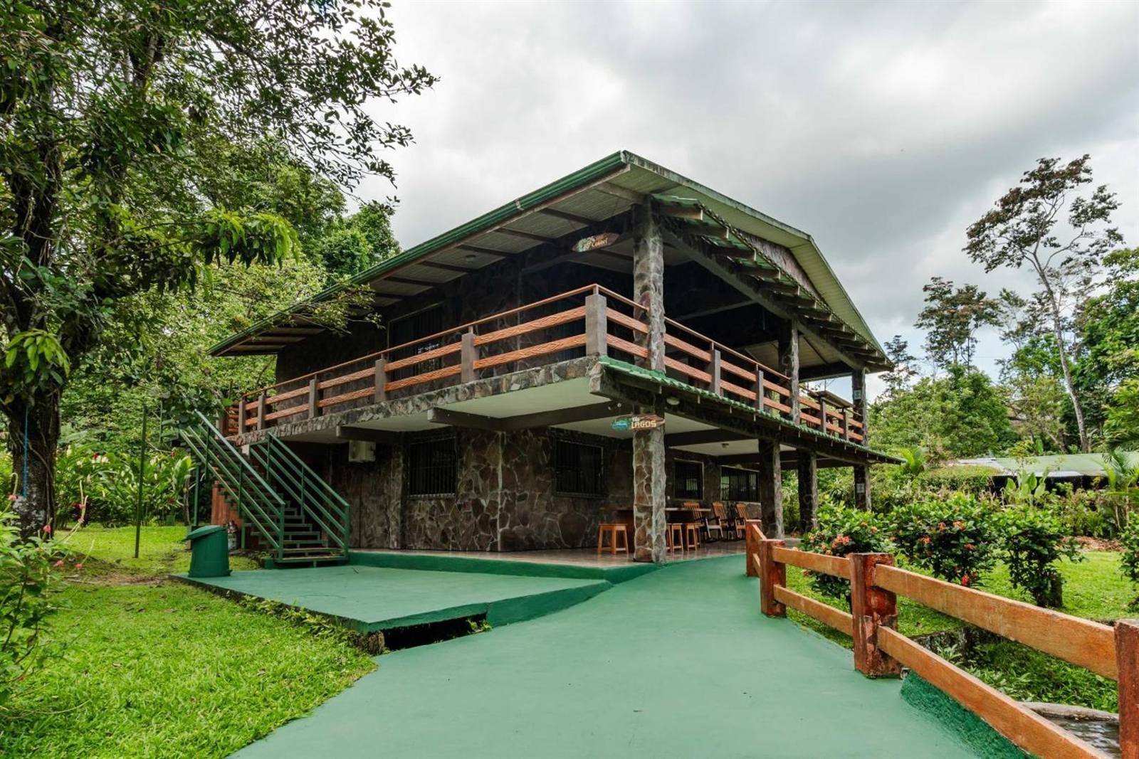 Wooden house with a balcony among the greenery