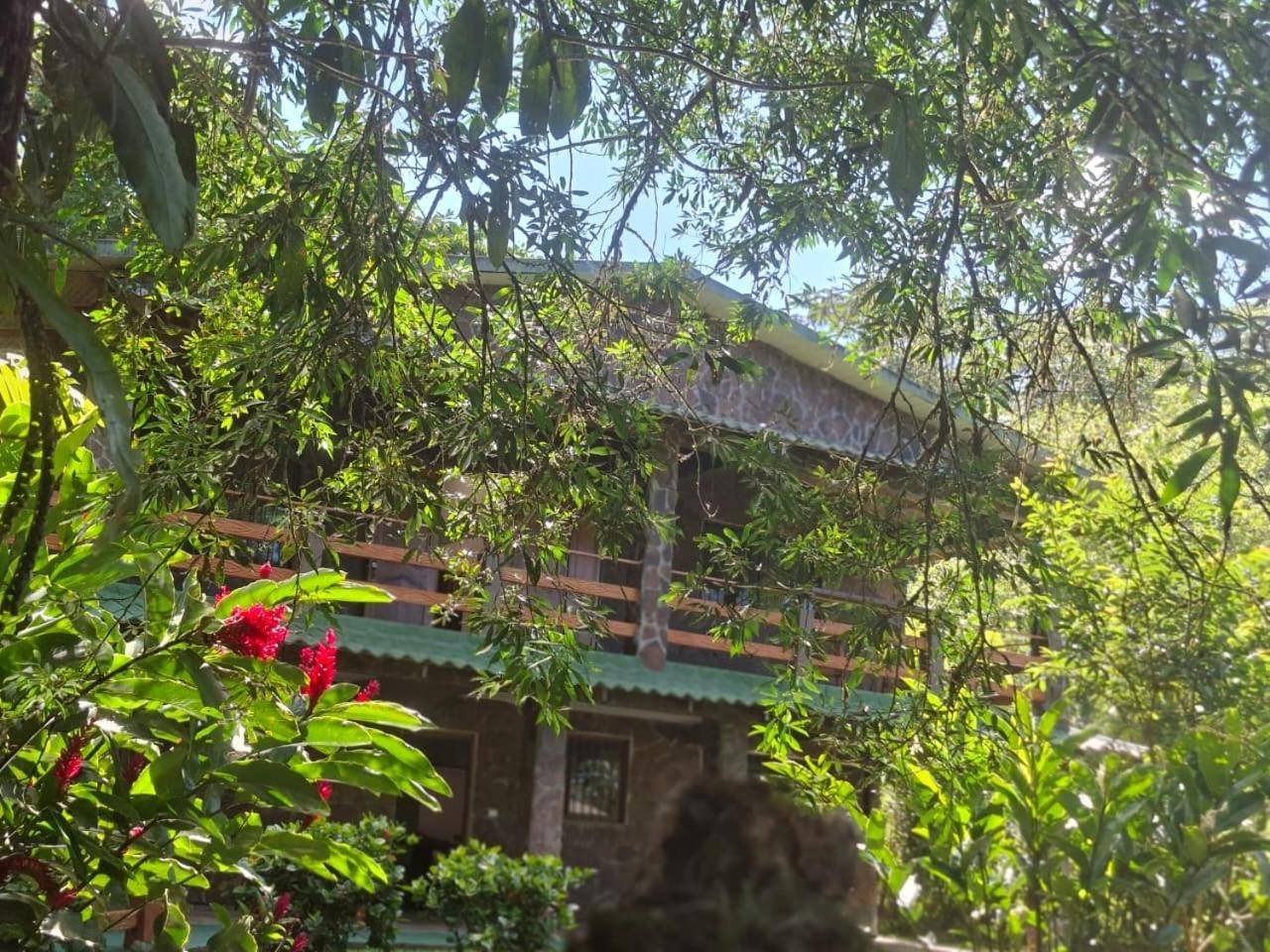 Two-story lodge building seen from the garden